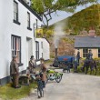 Touring motorcyclists study a map of the Lizard outside the 'Black Swan'